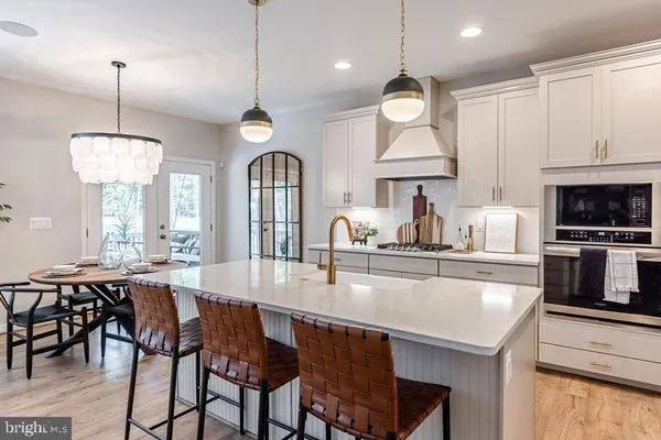a large kitchen with a table and chairs
