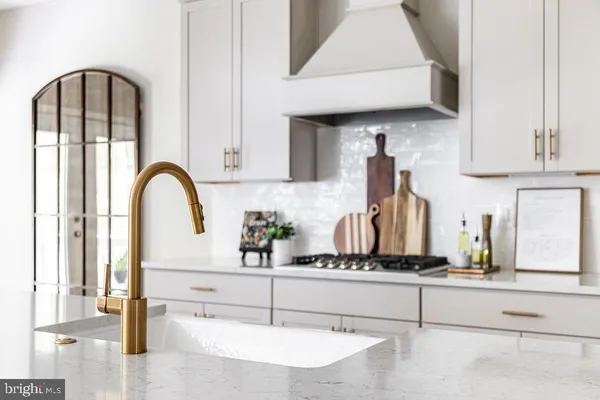 a kitchen with stainless steel appliances granite countertop a sink and cabinets