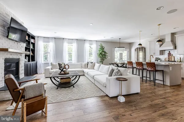 a living room with fireplace furniture and a fireplace
