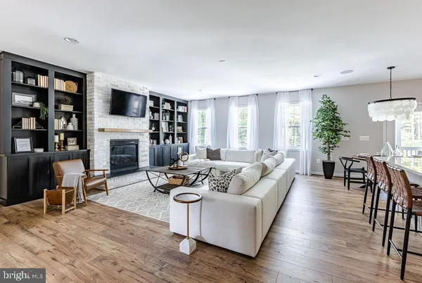 a living room with furniture flat screen tv and a fireplace