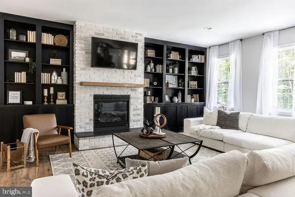 a living room with furniture fireplace and a flat screen tv