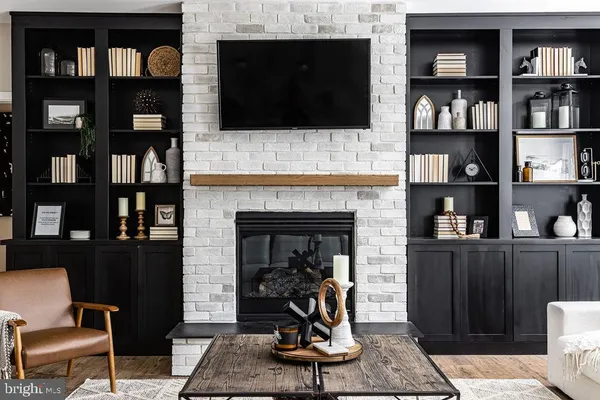 a living room with fireplace furniture and a flat screen tv