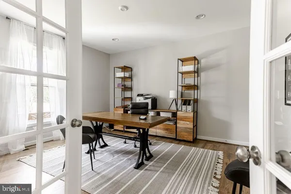 a view of a workspace with furniture and a window
