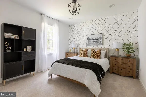 a spacious bedroom with a bed and a cabinets