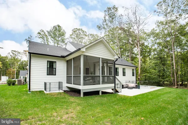 a view of a house with a backyard and a patio