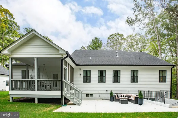 a aerial view of a house with a porch and a yard