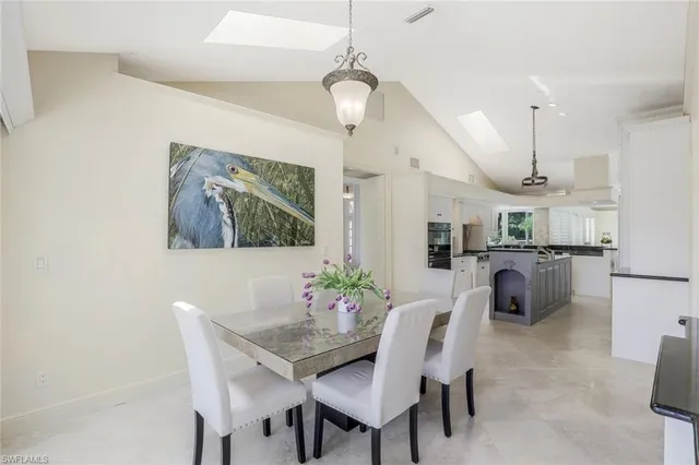 a view of a dining room with furniture and a chandelier