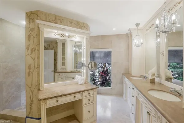 a bathroom with a granite countertop sink a mirror and a shower