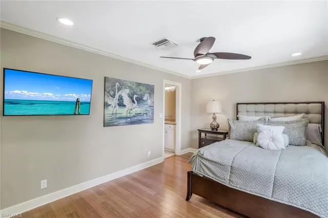 a bedroom with a bed and a painting on the wall