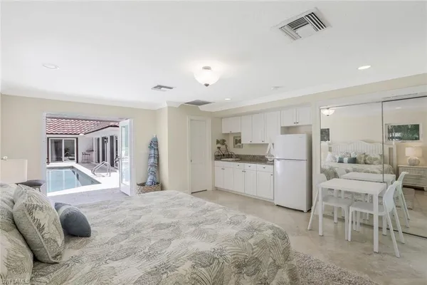 a large white bed in a white room