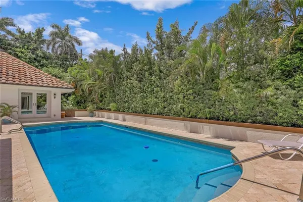 swimming pool view with sitting space and garden view
