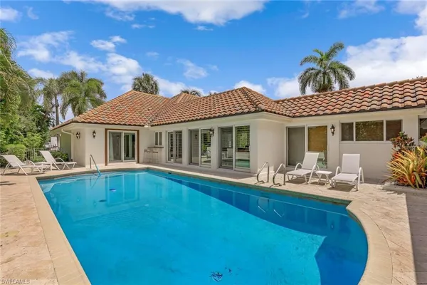 a front view of house with yard outdoor seating and barbeque oven