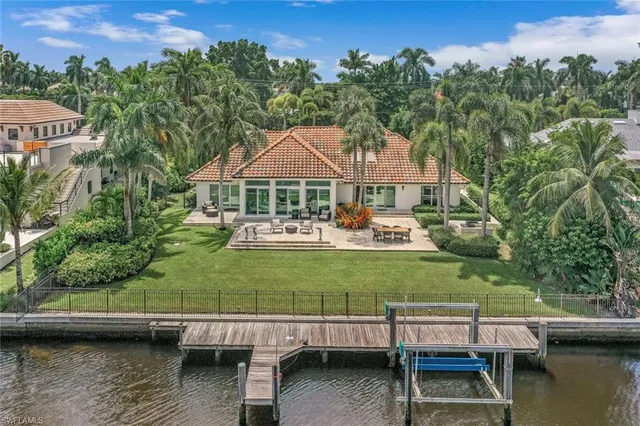 a view of a lake with a patio table and chairs