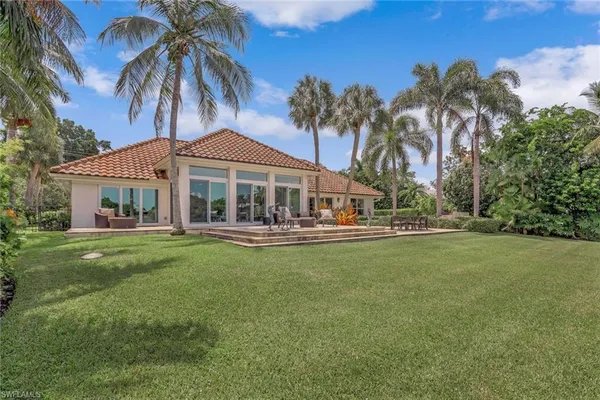 a front view of a house with swimming pool having outdoor seating