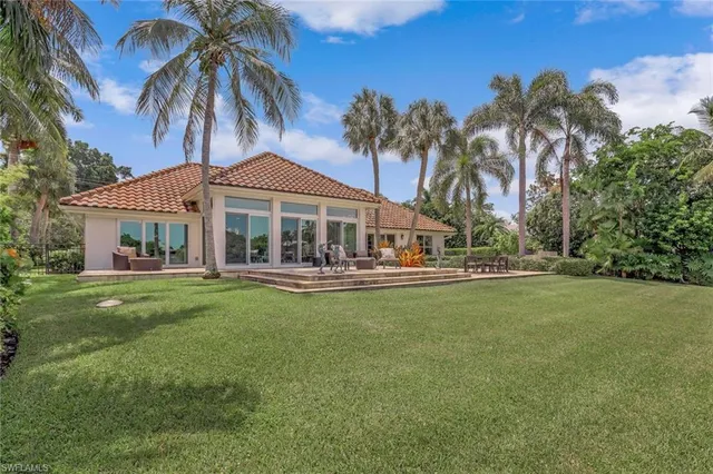 a front view of a house with swimming pool having outdoor seating