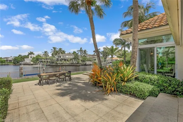 a view of a patio with table and chairs and potted plants