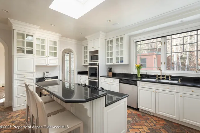 a kitchen with granite countertop a sink and cabinets