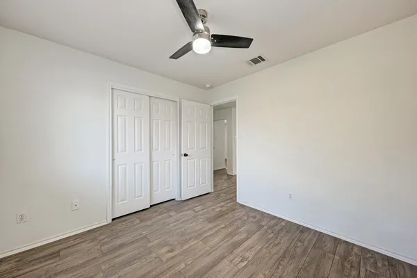 a view of an empty room with a ceiling fan
