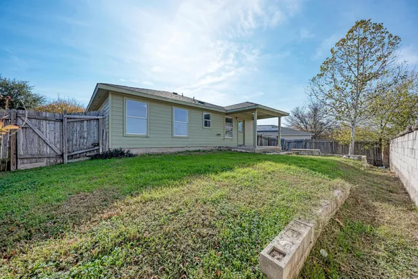 an aerial view of a house with a yard and lake view