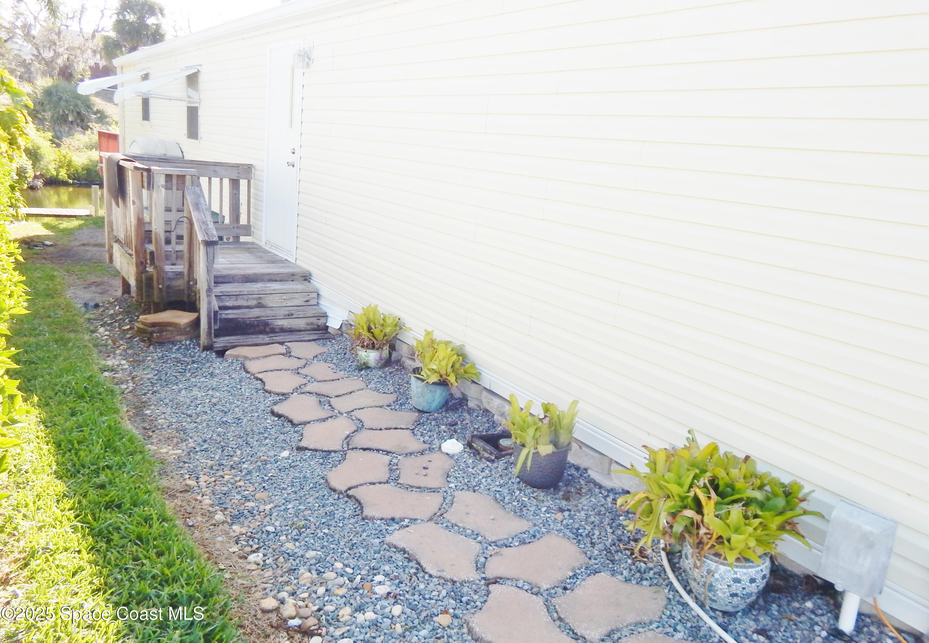 3016 Indian River Drive Northeast Palm Bay, FL 32905 - Photo 1 of 27 a view of a pathway with flower plants