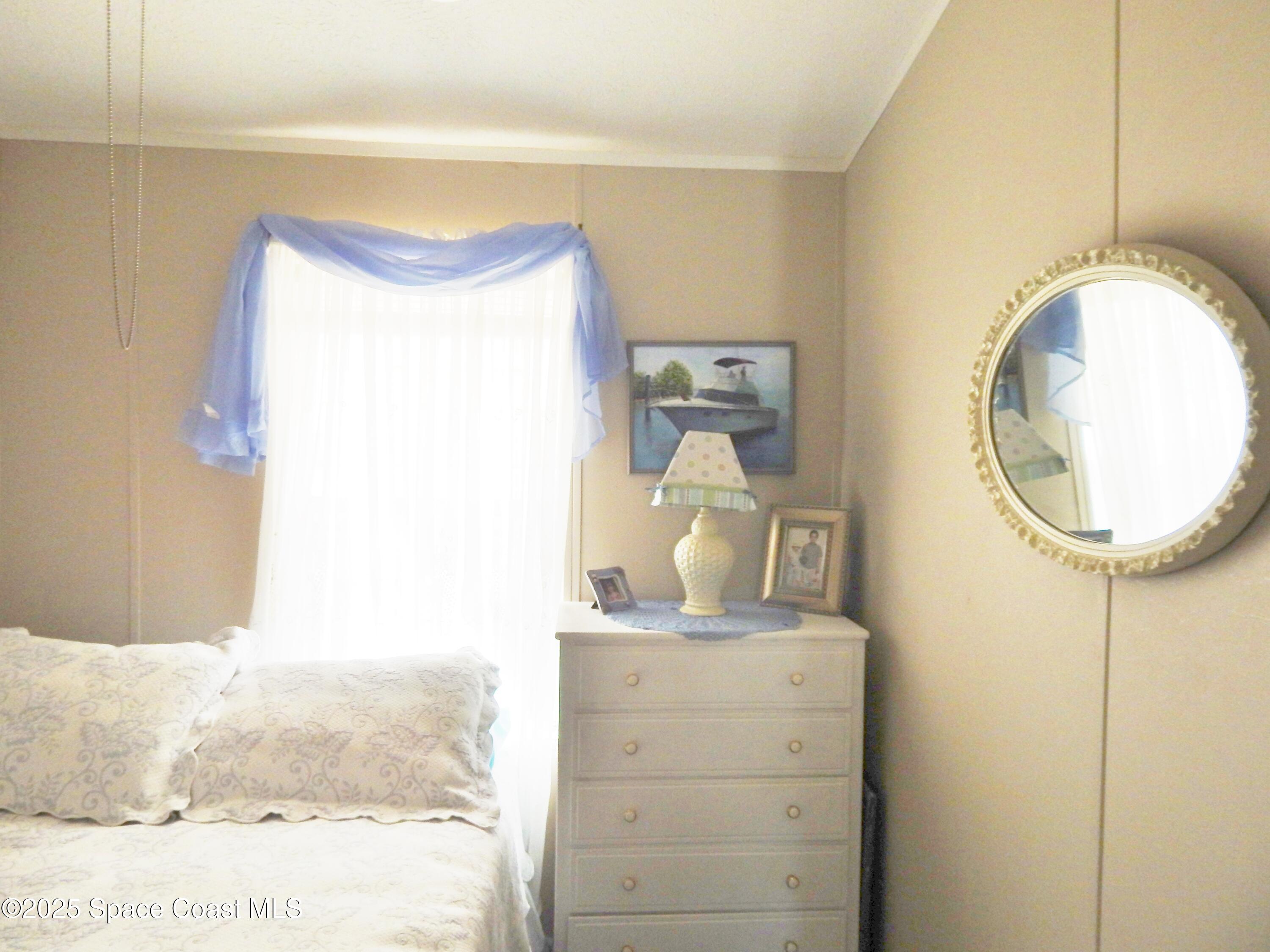 3016 Indian River Drive Northeast Palm Bay, FL 32905 - Photo 18 of 27 a bathroom with a mirror and a sink