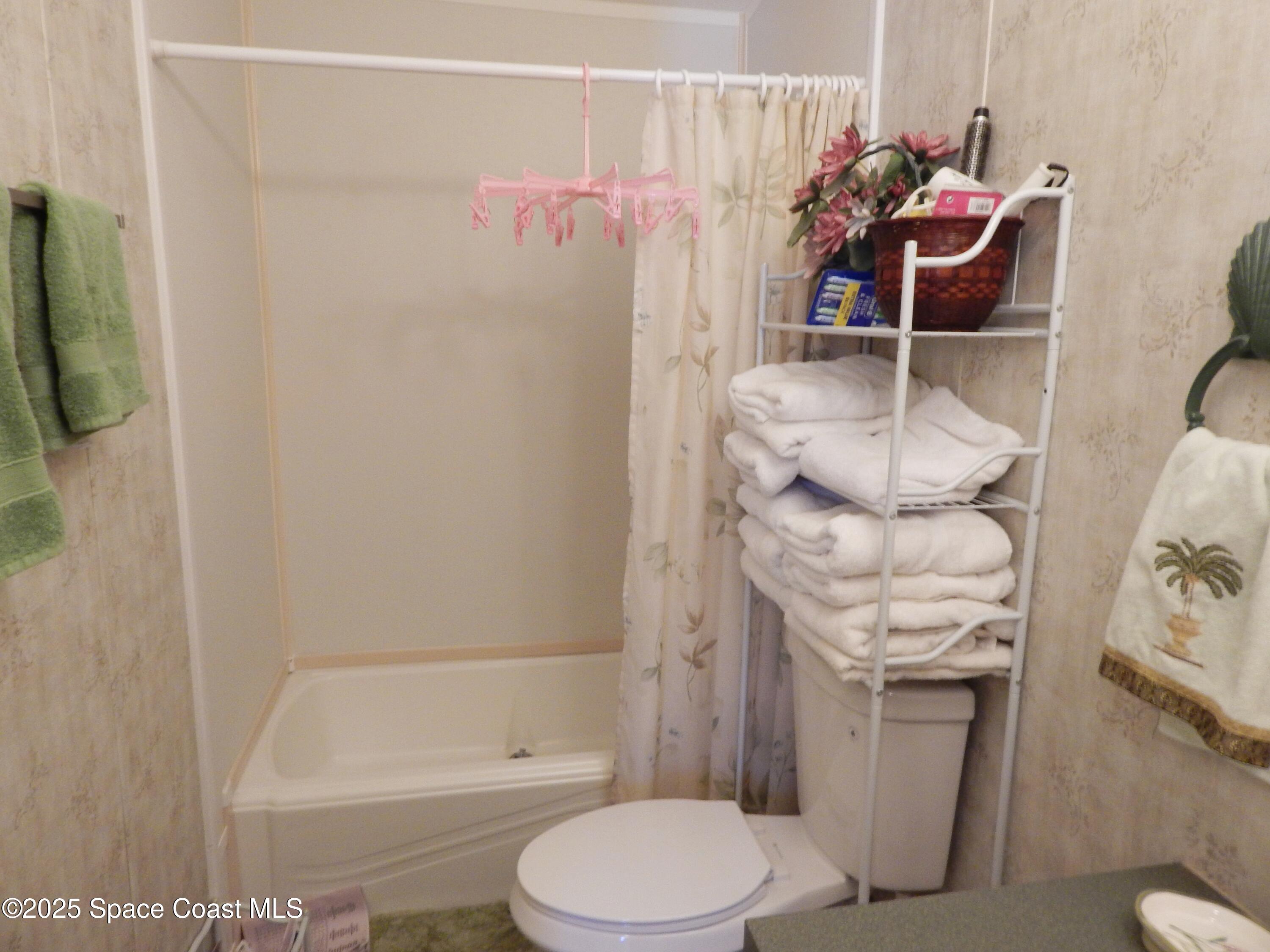 3016 Indian River Drive Northeast Palm Bay, FL 32905 - Photo 23 of 27 a bathroom with a sink toilet and shower