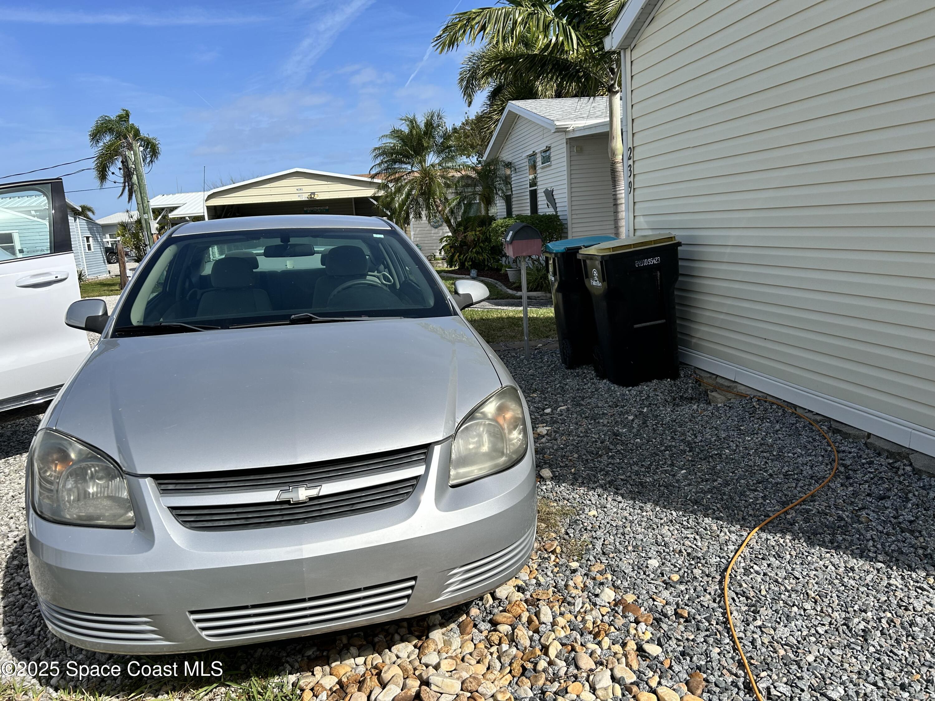 3016 Indian River Drive Northeast Palm Bay, FL 32905 - Photo 25 of 27 a car parked in front of a house