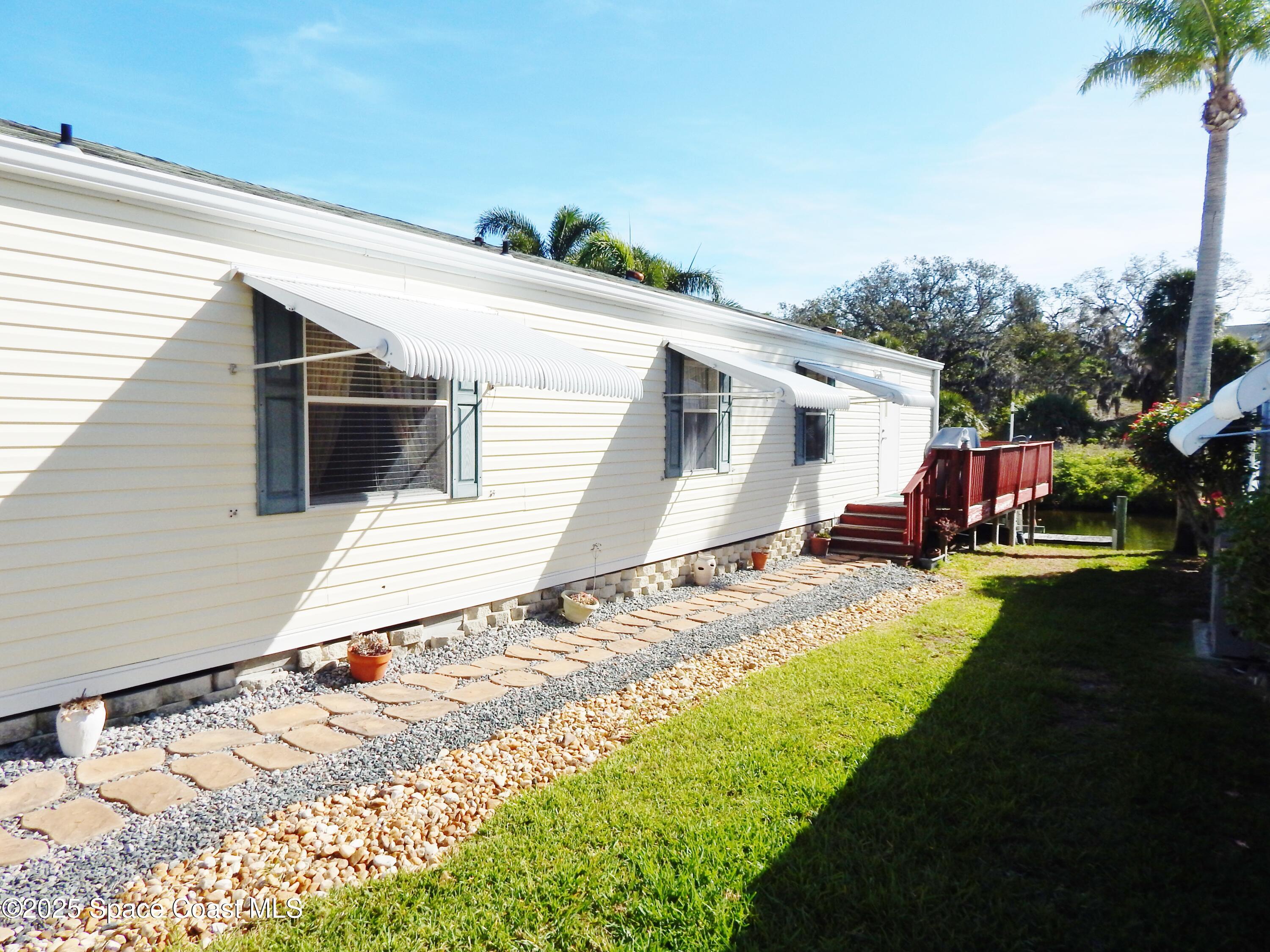 3016 Indian River Drive Northeast Palm Bay, FL 32905 - Photo 4 of 27 a view of a backyard of the house