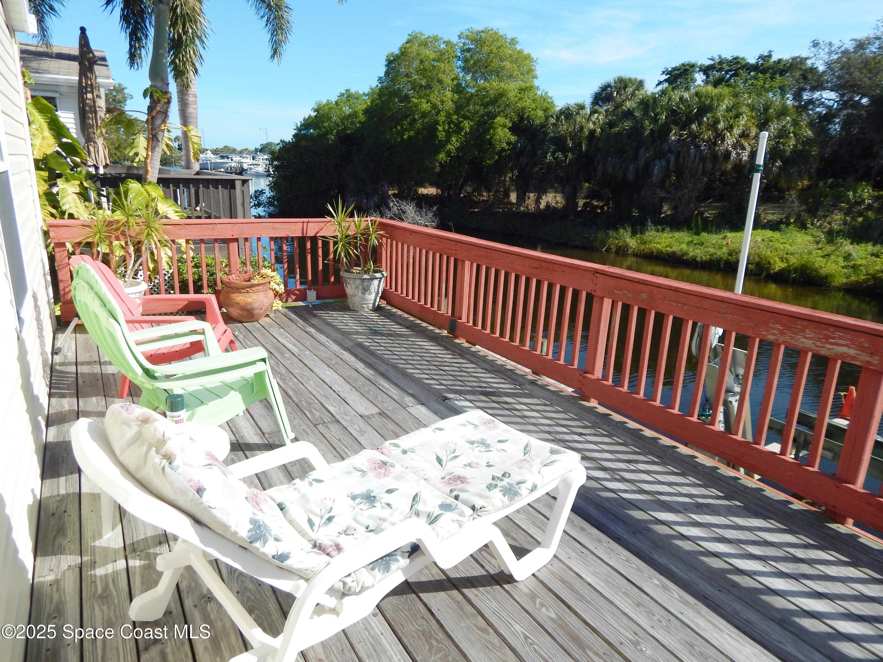 3016 Indian River Drive Northeast Palm Bay, FL 32905 - Photo 9 of 27 a view of balcony with wooden floor outdoor seating and yard in the back