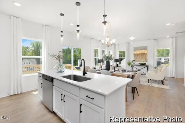 a very nice looking dining room with a large dining table and chairs