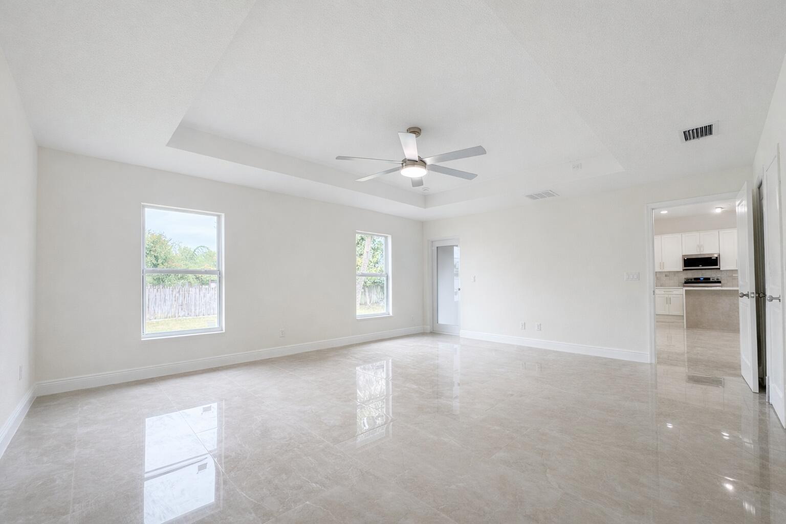 655 Southwest Seagull Terrace Port St. Lucie, FL 34953 - Photo 12 of 24 an empty room with chandelier fan and windows