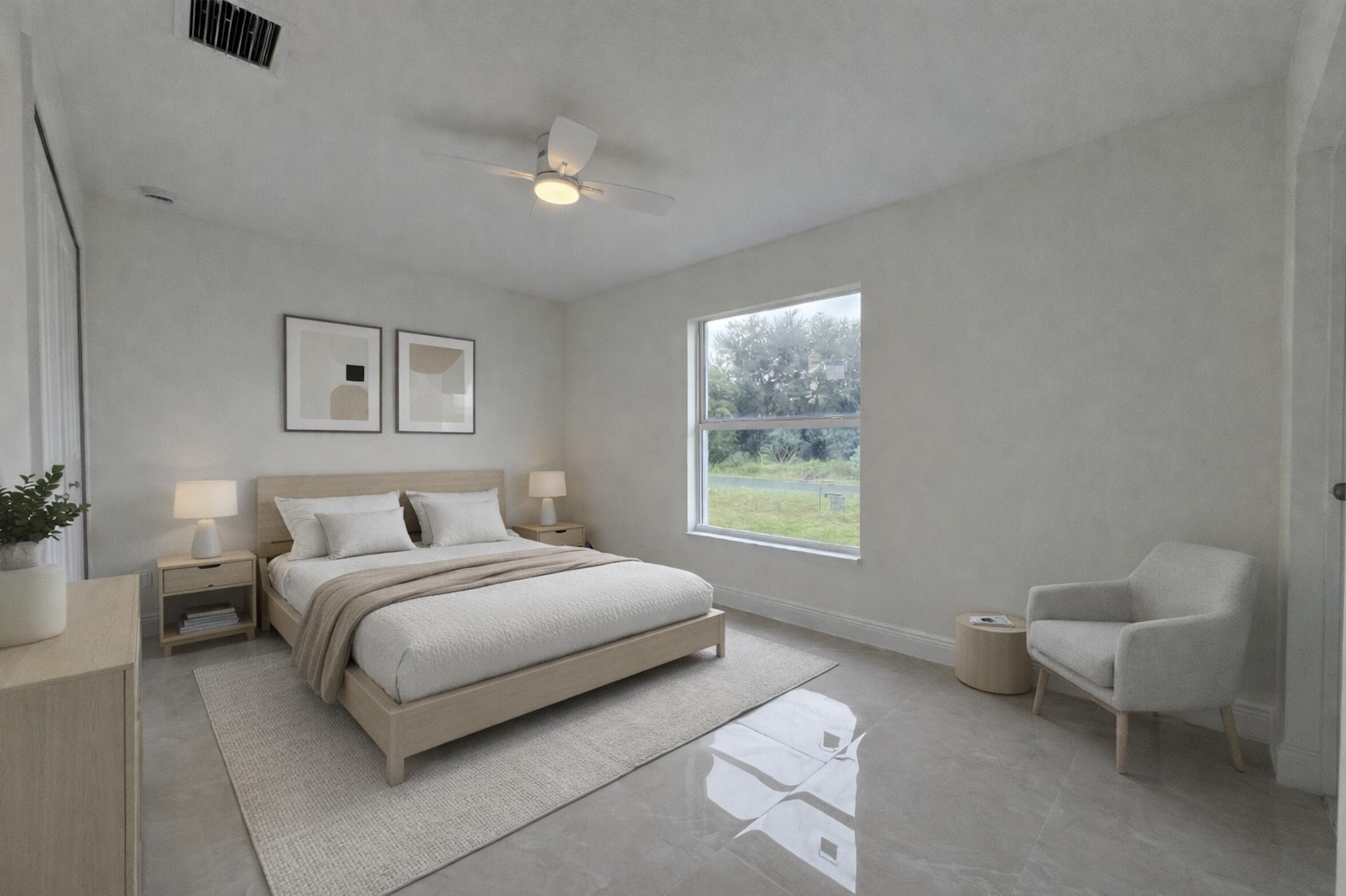 655 Southwest Seagull Terrace Port St. Lucie, FL 34953 - Photo 14 of 24 a spacious bedroom with a bed and a couch