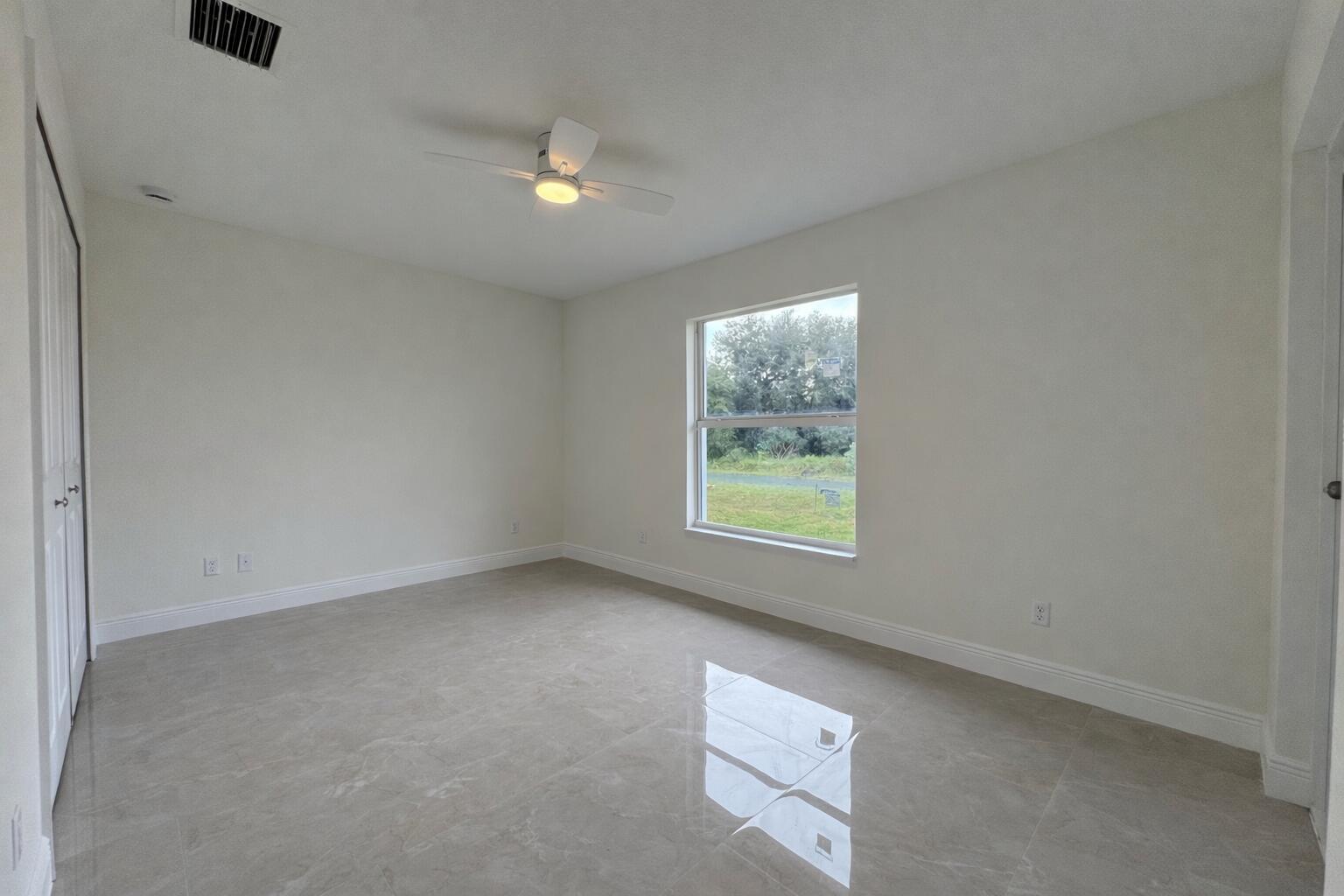 655 Southwest Seagull Terrace Port St. Lucie, FL 34953 - Photo 15 of 24 an empty room with a window