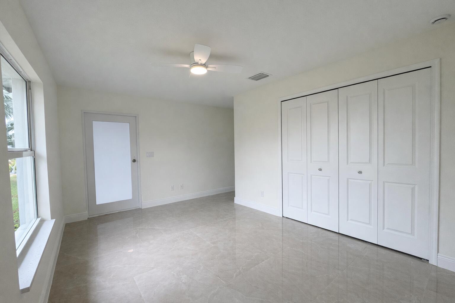 655 Southwest Seagull Terrace Port St. Lucie, FL 34953 - Photo 16 of 24 a view of an empty room with a window