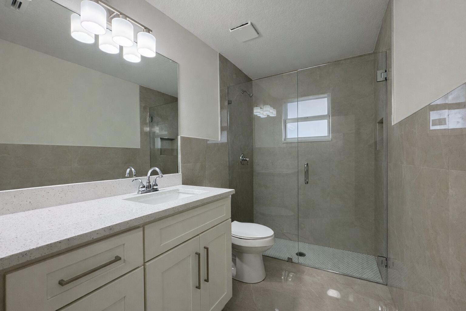 655 Southwest Seagull Terrace Port St. Lucie, FL 34953 - Photo 17 of 24 a bathroom with a sink a toilet and shower
