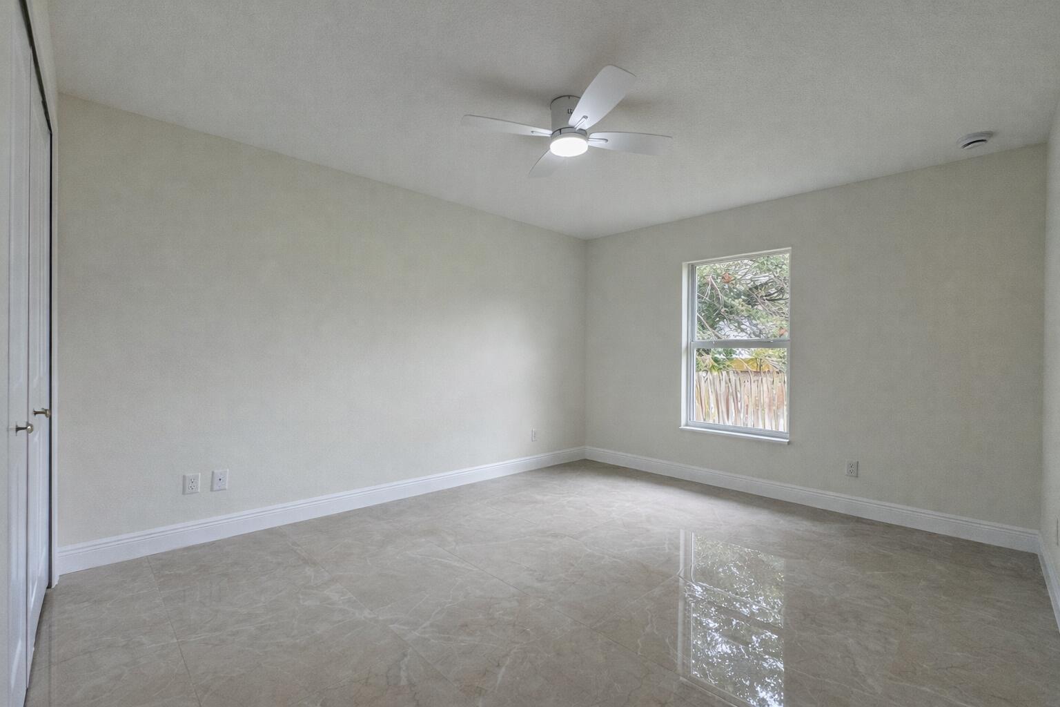 655 Southwest Seagull Terrace Port St. Lucie, FL 34953 - Photo 20 of 24 a view of an empty room with a window