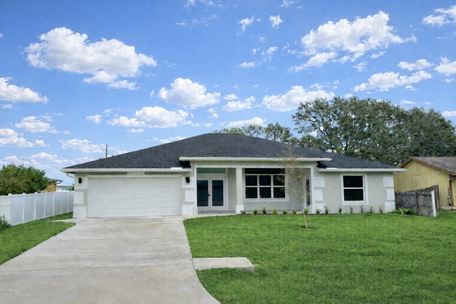 655 Southwest Seagull Terrace Port St. Lucie, FL 34953 - Photo 2 of 24 front view of a house with a yard