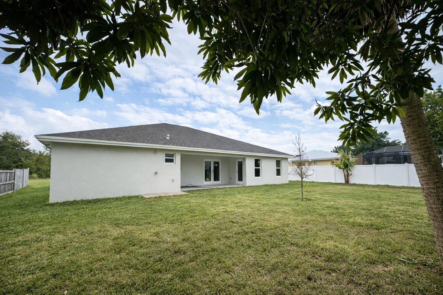 655 Southwest Seagull Terrace Port St. Lucie, FL 34953 - Photo 23 of 24 a house with a tree in front of it