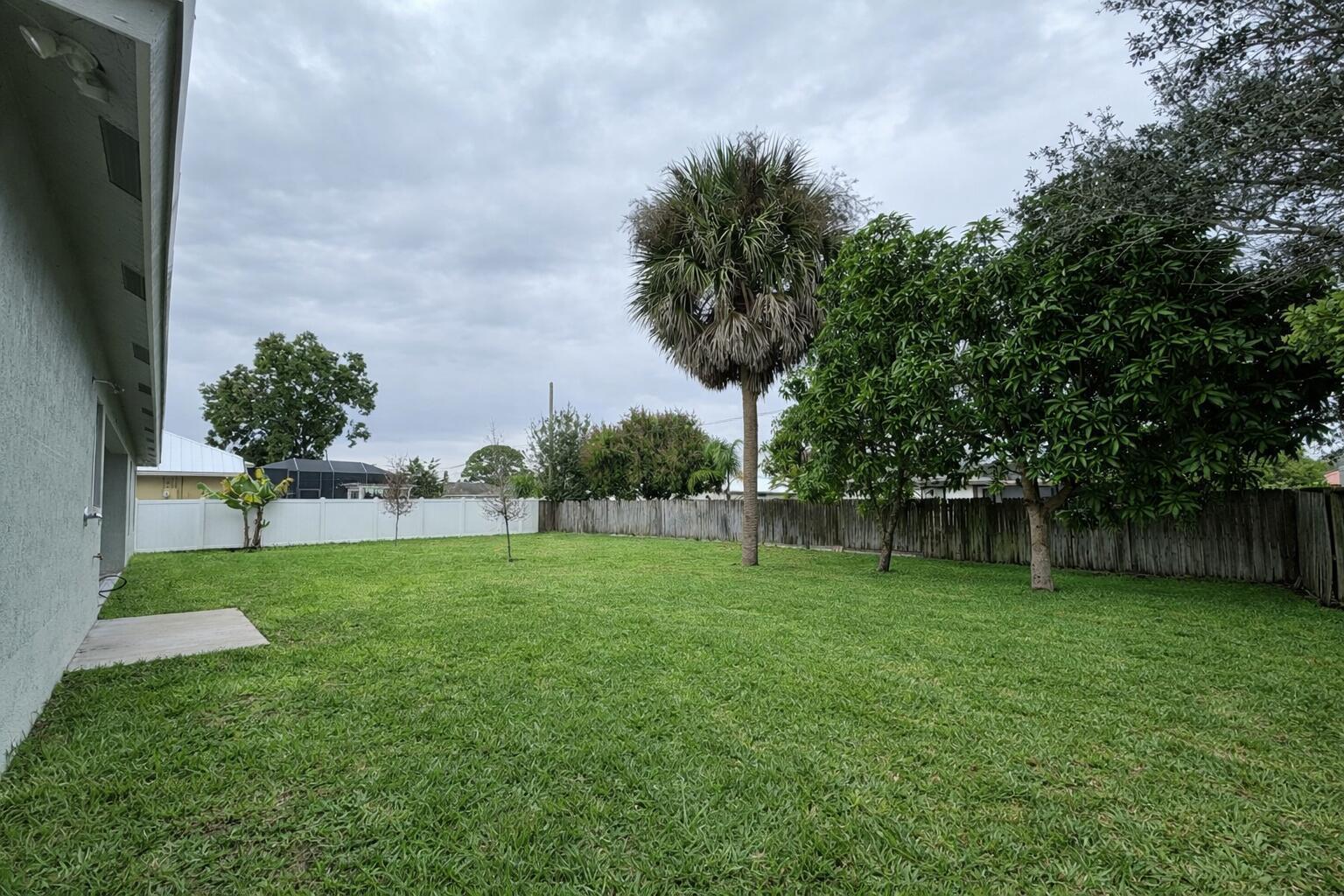 655 Southwest Seagull Terrace Port St. Lucie, FL 34953 - Photo 24 of 24 a view of a backyard with green space