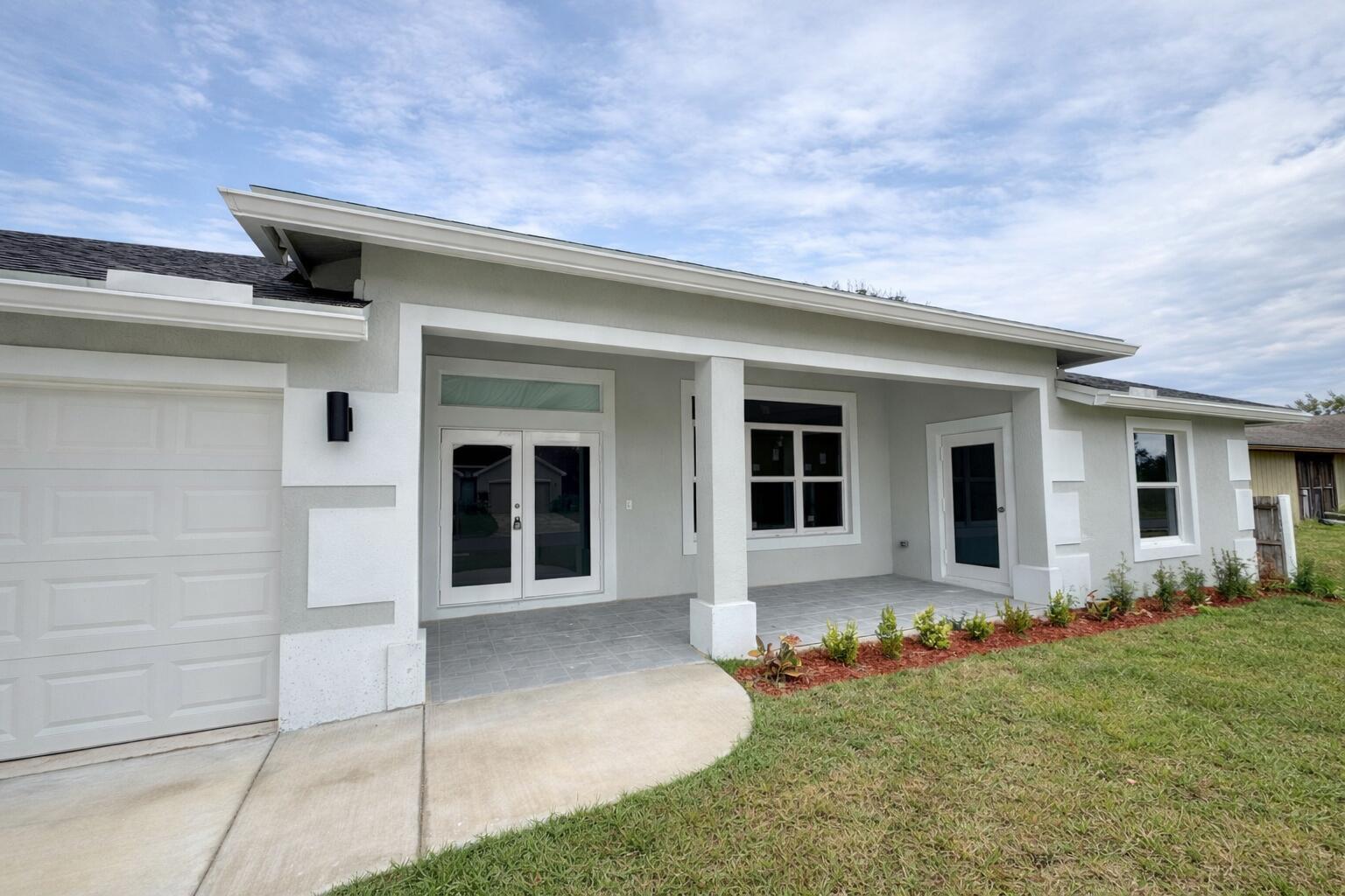 655 Southwest Seagull Terrace Port St. Lucie, FL 34953 - Photo 3 of 24 front view of house with a yard