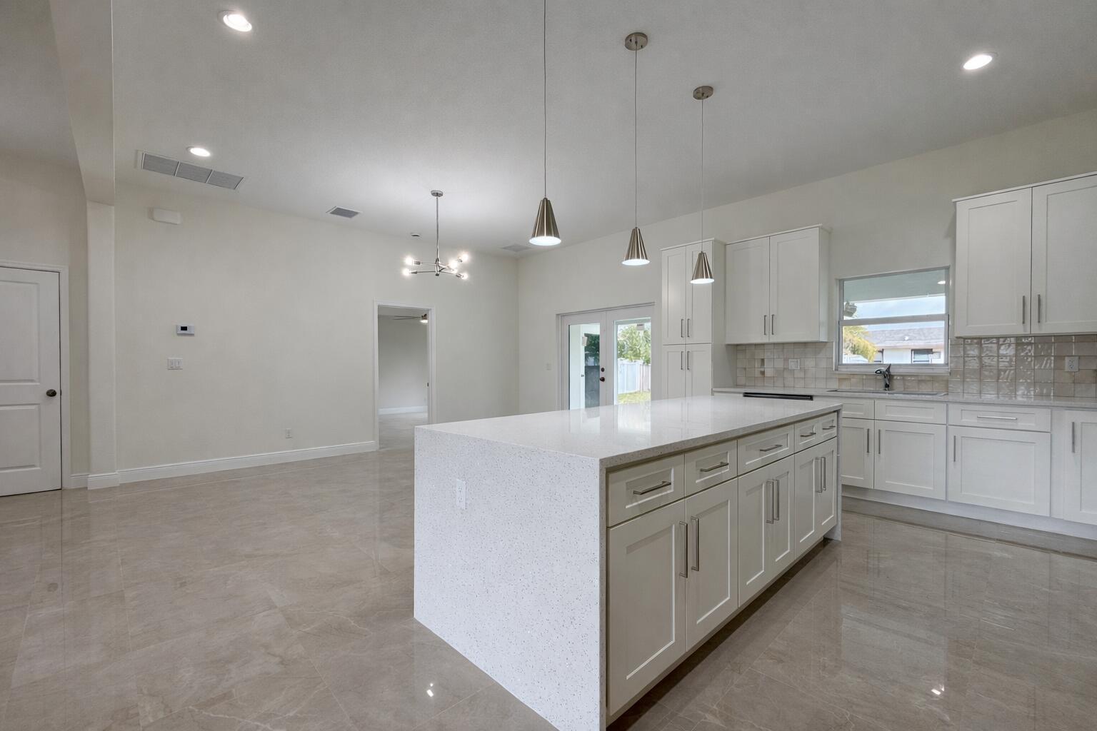655 Southwest Seagull Terrace Port St. Lucie, FL 34953 - Photo 5 of 24 a large kitchen with cabinets