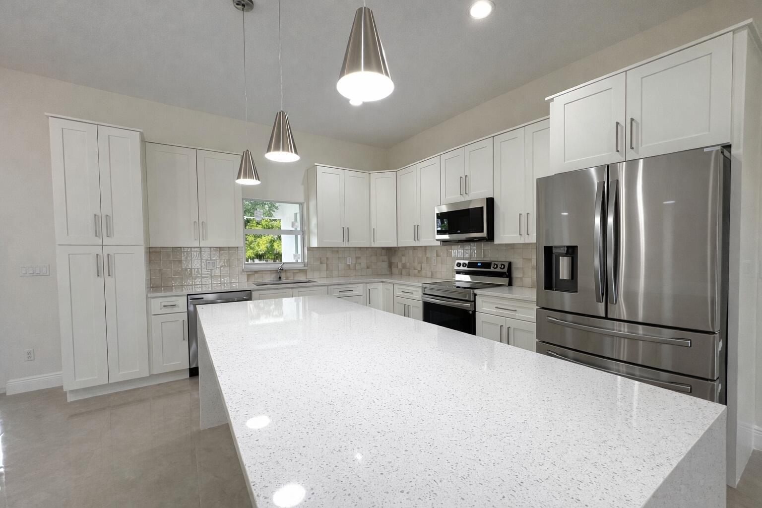 655 Southwest Seagull Terrace Port St. Lucie, FL 34953 - Photo 6 of 24 a kitchen with granite countertop a refrigerator oven a sink and dishwasher