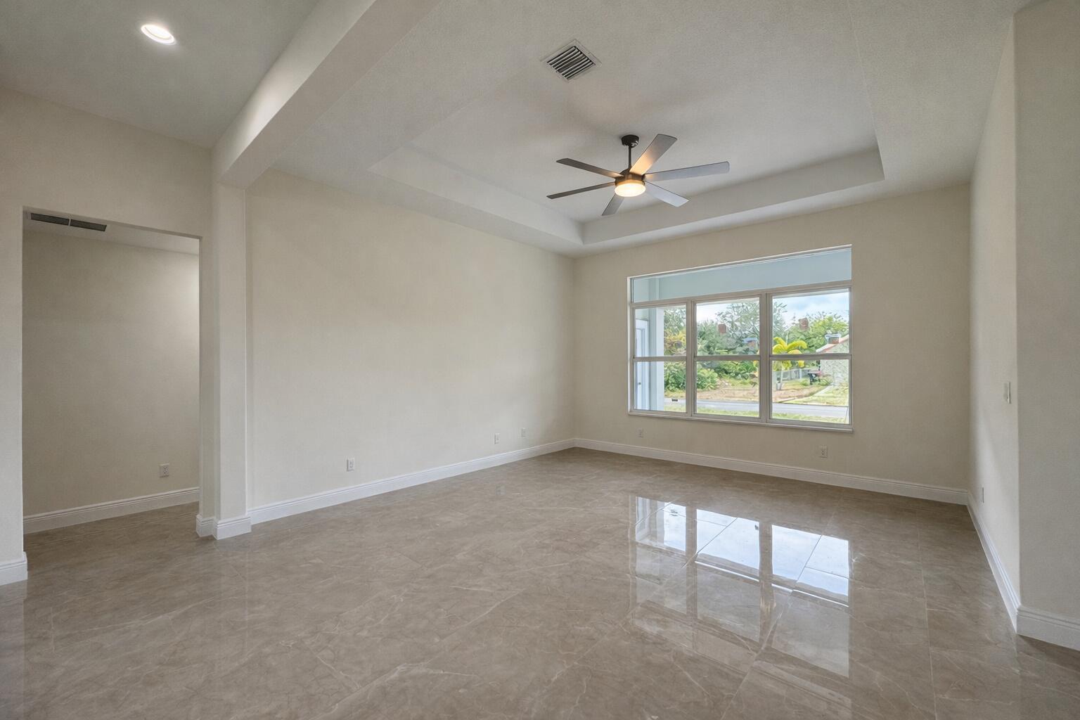 655 Southwest Seagull Terrace Port St. Lucie, FL 34953 - Photo 8 of 24 an empty room with windows and ceiling fan