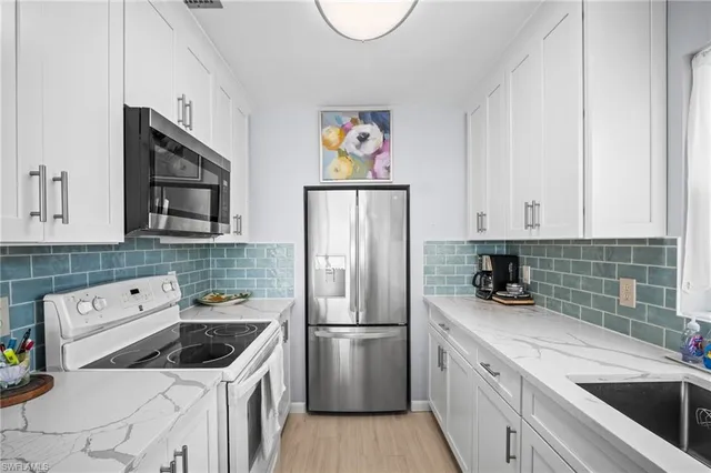 a kitchen with a sink a stove and cabinets