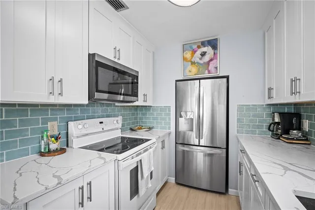 a kitchen with a refrigerator stove and microwave