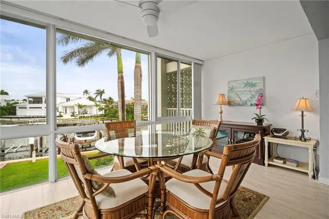 a dining room with furniture a chandelier and wooden floor