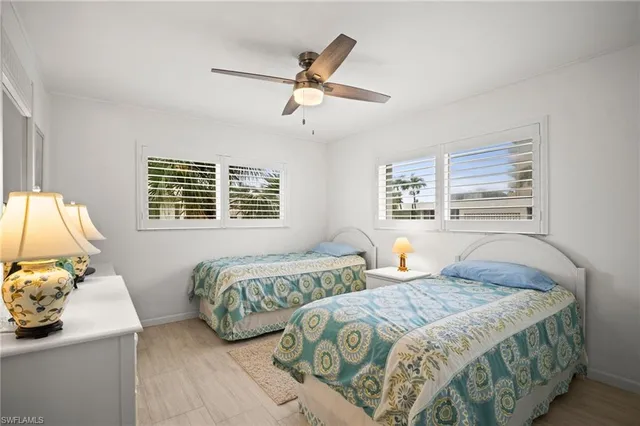 a bedroom with two beds and a window