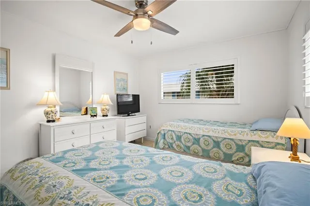 a bedroom with a bed a couch and dresser