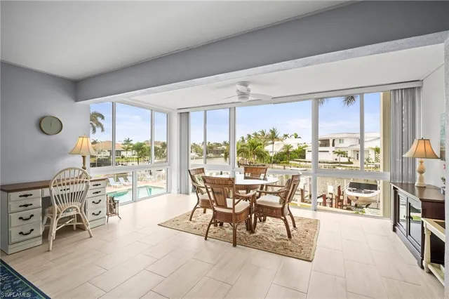 a dining area with furniture and a large window