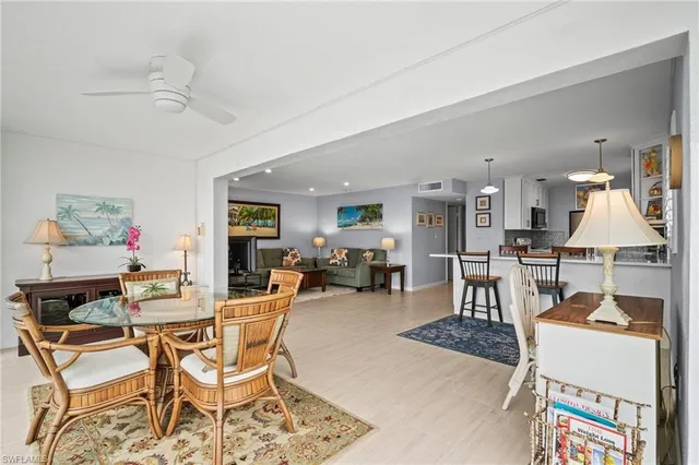 a dining room with wooden floor and breakfast area